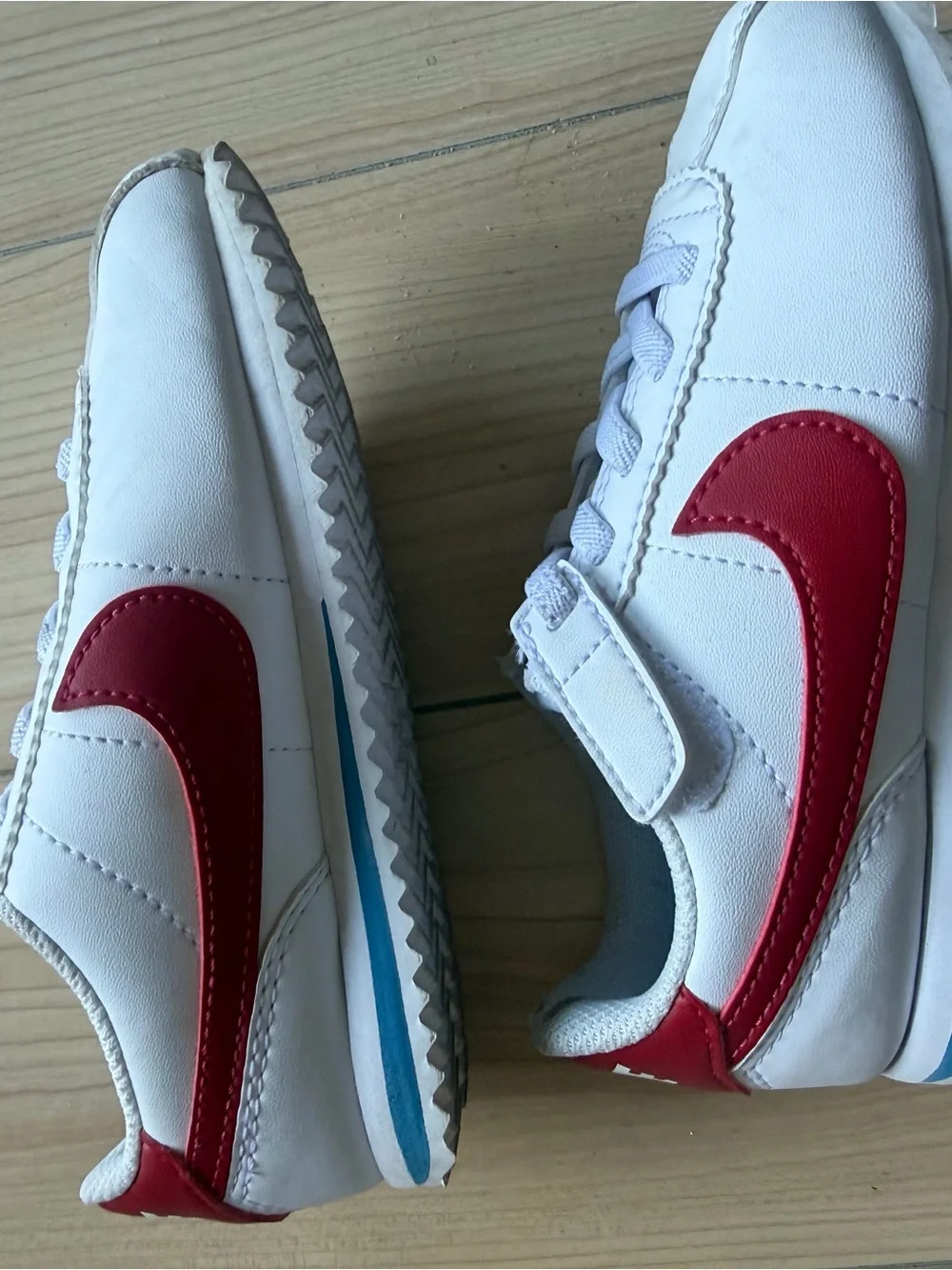 Nike Kids White Sneakers with Red Swoosh